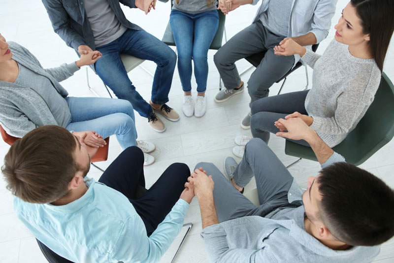 A group of people sitting in a circle.
