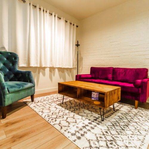 A living room with a couch and chair