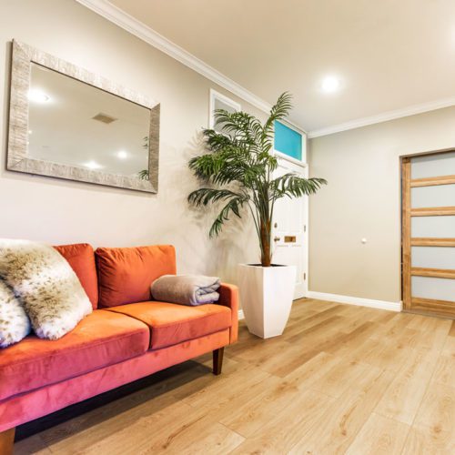 A living room with hardwood floors and a couch.