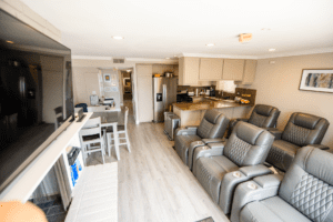A living room with leather chairs and a television.