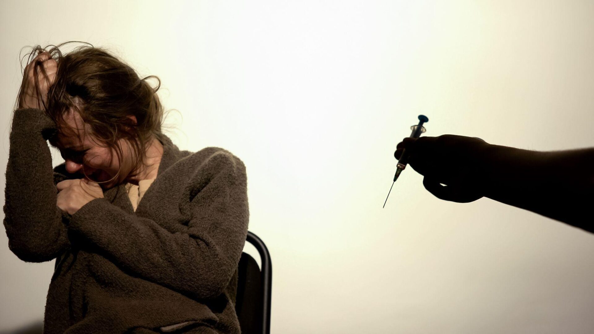 A person holding a small object in their hand.