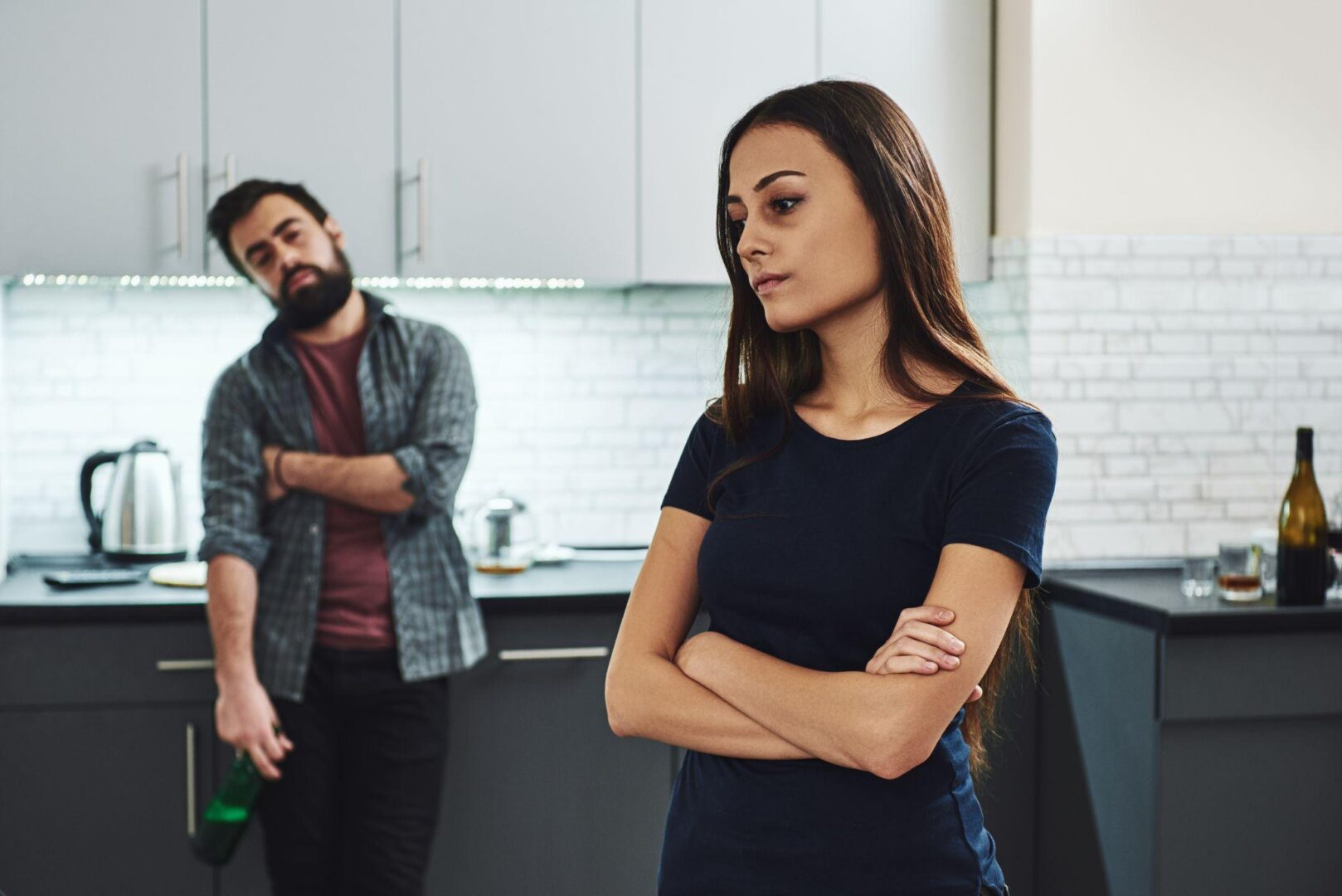 A man and woman standing in the kitchen