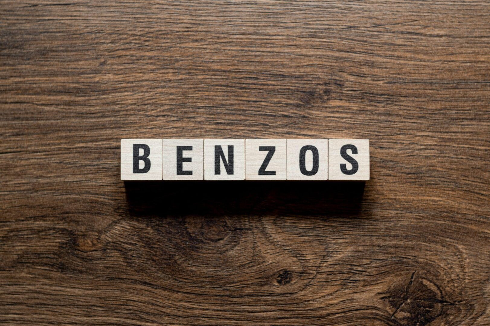 A wooden table with the word benzos written on it.